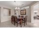 Formal dining room featuring a modern chandelier and an abstract art piece adds elegance at 15850 W Silver Breeze Dr, Surprise, AZ 85374