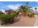 Single-Gathering house with desert landscaping and palm trees in front, with blue skies and clouds above at 15850 W Silver Breeze Dr, Surprise, AZ 85374