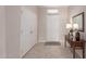 Welcoming foyer with tile flooring, coat closet, and console table, offering a bright entry at 15850 W Silver Breeze Dr, Surprise, AZ 85374