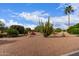 Beautiful desert landscaping with ocotillo, various trees and bushes set against a beautiful cloudy blue sky at 15850 W Silver Breeze Dr, Surprise, AZ 85374