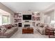 Spacious living room featuring dual sofas, a cozy fireplace, and stylish decor for a welcoming atmosphere at 15850 W Silver Breeze Dr, Surprise, AZ 85374