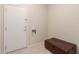 Entry way featuring a tile floor, a white door, and a leather bench at 15850 W Silver Breeze Dr, Surprise, AZ 85374