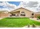 Beautiful backyard featuring a well-kept lawn, desert landscape, and covered patio at 16388 N 99Th Pl, Scottsdale, AZ 85260