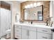 Stylish bathroom featuring a white vanity, modern lighting, and a decorative backsplash, blending functionality and style at 16388 N 99Th Pl, Scottsdale, AZ 85260