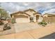 Inviting single-level home featuring desert landscaping and attached two-car garage at 16388 N 99Th Pl, Scottsdale, AZ 85260