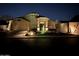 Inviting home exterior featuring desert landscaping with stylish accent lighting at night at 16388 N 99Th Pl, Scottsdale, AZ 85260