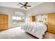 Spacious main bedroom with vaulted ceilings and window to backyard; complete with built in cabinets and shelves at 16388 N 99Th Pl, Scottsdale, AZ 85260