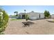 Backyard view featuring the home, pool, and minimalist xeriscaped landscaping at 16409 N 62Nd Way, Scottsdale, AZ 85254