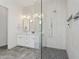 Modern bathroom featuring a double sink vanity, and a frameless glass shower with gray tile at 16409 N 62Nd Way, Scottsdale, AZ 85254