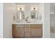 Bright bathroom featuring a double vanity with framed mirrors and ample storage at 16409 N 62Nd Way, Scottsdale, AZ 85254