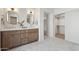 Bright bathroom featuring a double vanity, with a closet for extra storage at 16409 N 62Nd Way, Scottsdale, AZ 85254