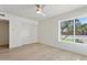 Bright bedroom featuring hardwood floors, large windows, and a ceiling fan at 16409 N 62Nd Way, Scottsdale, AZ 85254