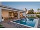 Inviting outdoor space with a dining area, lounge seating, and views of a refreshing pool and landscaping at 16409 N 62Nd Way, Scottsdale, AZ 85254