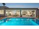 Covered patio featuring a dining and seating area with a view of the sparkling pool at 16409 N 62Nd Way, Scottsdale, AZ 85254