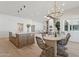 Open-concept dining area with stylish chandelier, fireplace and comfortable seating at 16409 N 62Nd Way, Scottsdale, AZ 85254