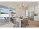 Bright dining area with wicker chairs, modern chandelier, and sliding doors to outdoor patio at 16409 N 62Nd Way, Scottsdale, AZ 85254