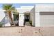 Front entrance featuring a brick walkway, desert landscaping, and a stucco facade with a black front door at 16409 N 62Nd Way, Scottsdale, AZ 85254