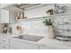 Clean and modern kitchen countertop with a cooktop, decorative items, and stainless vent at 16409 N 62Nd Way, Scottsdale, AZ 85254