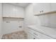 Clean laundry room with ample counter space and storage cabinets at 16409 N 62Nd Way, Scottsdale, AZ 85254