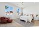 Serene main bedroom with large windows, a ceiling fan and a cozy sitting area at 16409 N 62Nd Way, Scottsdale, AZ 85254