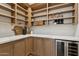 Spacious pantry with custom cabinetry, quartz countertop, wine fridge, and open shelving at 16409 N 62Nd Way, Scottsdale, AZ 85254