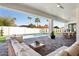 Inviting pool area with comfortable seating and a view of the lush landscaping at 16409 N 62Nd Way, Scottsdale, AZ 85254