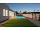 A pristine pool is surrounded by lush turf and brick accents in this backyard oasis at 16409 N 62Nd Way, Scottsdale, AZ 85254