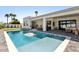 Backyard pool and patio area, featuring a covered seating area, an artificial lawn, and privacy landscaping at 16409 N 62Nd Way, Scottsdale, AZ 85254