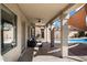 Covered back patio with ceiling fan and pillars, overlooking a pool and backyard at 16617 S 16Th Ave, Phoenix, AZ 85045