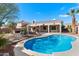 Lush backyard featuring a sparkling pool, covered patio, and inviting lounge area at 16617 S 16Th Ave, Phoenix, AZ 85045