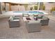 Backyard patio with a central fire pit and comfortable seating for outdoor entertaining near pool at 16617 S 16Th Ave, Phoenix, AZ 85045