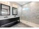 Modern bathroom with double vanities, sleek fixtures, tiled shower, and natural light at 16617 S 16Th Ave, Phoenix, AZ 85045