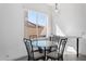 Bright breakfast nook featuring a glass table, modern chairs, and a window with a view at 16617 S 16Th Ave, Phoenix, AZ 85045