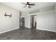 Neutral living area features tile floors, a ceiling fan, and open doorways for easy flow at 16617 S 16Th Ave, Phoenix, AZ 85045