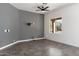 A bright living room with neutral paint, gray tile floors, and a large window overlooking the pool area at 16617 S 16Th Ave, Phoenix, AZ 85045