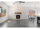 Bright living room boasts open space, fireplace with wooden mantle, and dining area at 16617 S 16Th Ave, Phoenix, AZ 85045