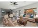 Comfortable living room with plush seating, view of pool, and natural light from the large windows at 16617 S 16Th Ave, Phoenix, AZ 85045