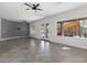 Open-concept living room featuring gray tile flooring, large windows, and view of pool at 16617 S 16Th Ave, Phoenix, AZ 85045