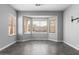 Open living room showcasing a bay window with natural light, gray tile flooring, and neutral color palette at 16617 S 16Th Ave, Phoenix, AZ 85045