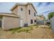 Backyard with a two-story home, some greenery, and low-maintenance desert landscaping at 18823 N 41St Dr, Glendale, AZ 85308