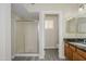 Well-lit bathroom with a shower and wooden vanity at 18823 N 41St Dr, Glendale, AZ 85308