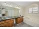 Double vanity bathroom with soaking tub and view into living area at 18823 N 41St Dr, Glendale, AZ 85308