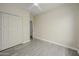 Neutral bedroom with light gray wood floors and white double door closet at 18823 N 41St Dr, Glendale, AZ 85308