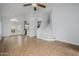 Open-concept living area featuring tile floors, a staircase, and views of the backyard through French doors at 18823 N 41St Dr, Glendale, AZ 85308
