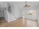 Open floor plan living area with a staircase and large window and a door to the outside at 18823 N 41St Dr, Glendale, AZ 85308