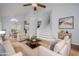 Living room with tile flooring, a staircase, and furnishings in the living area at 18823 N 41St Dr, Glendale, AZ 85308