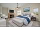 Main bedroom with a cozy fireplace, large bed, and stylish decorations at 18823 N 41St Dr, Glendale, AZ 85308
