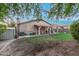 Rear view of home with covered patio, lawn, and storage shed at 1939 S Noble --, Mesa, AZ 85209