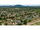 Panoramic aerial view of a residential neighborhood with lush green trees and mountain views in the distance at 19450 E Silver Creek Ln, Queen Creek, AZ 85142