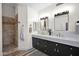 Modern bathroom with a double sink vanity, walk-in shower, and elegant neutral color palette at 19450 E Silver Creek Ln, Queen Creek, AZ 85142